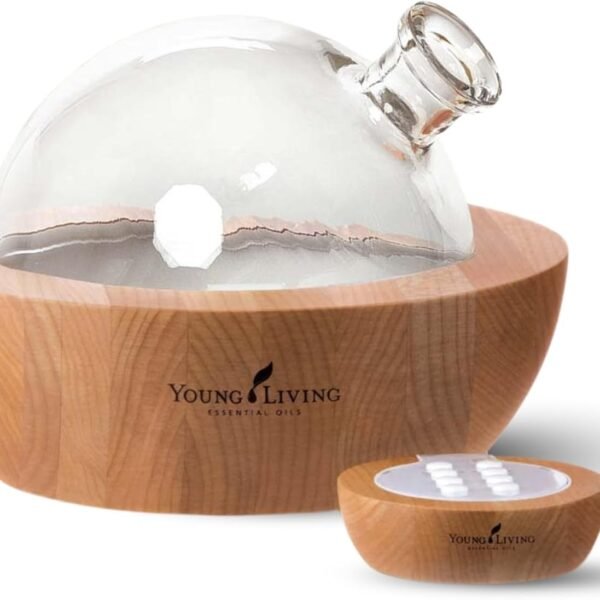 Young Living Aria ultrasonic essential oil diffuser with glass dome, wood-grain base, and remote control