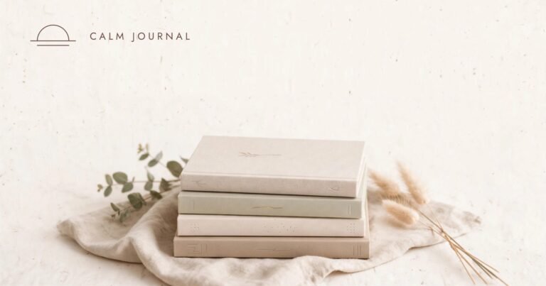 Stack of four neutral hardcover journals with dried grasses and eucalyptus on linen, Calm Journal cover for the 10 best self-improvement books post