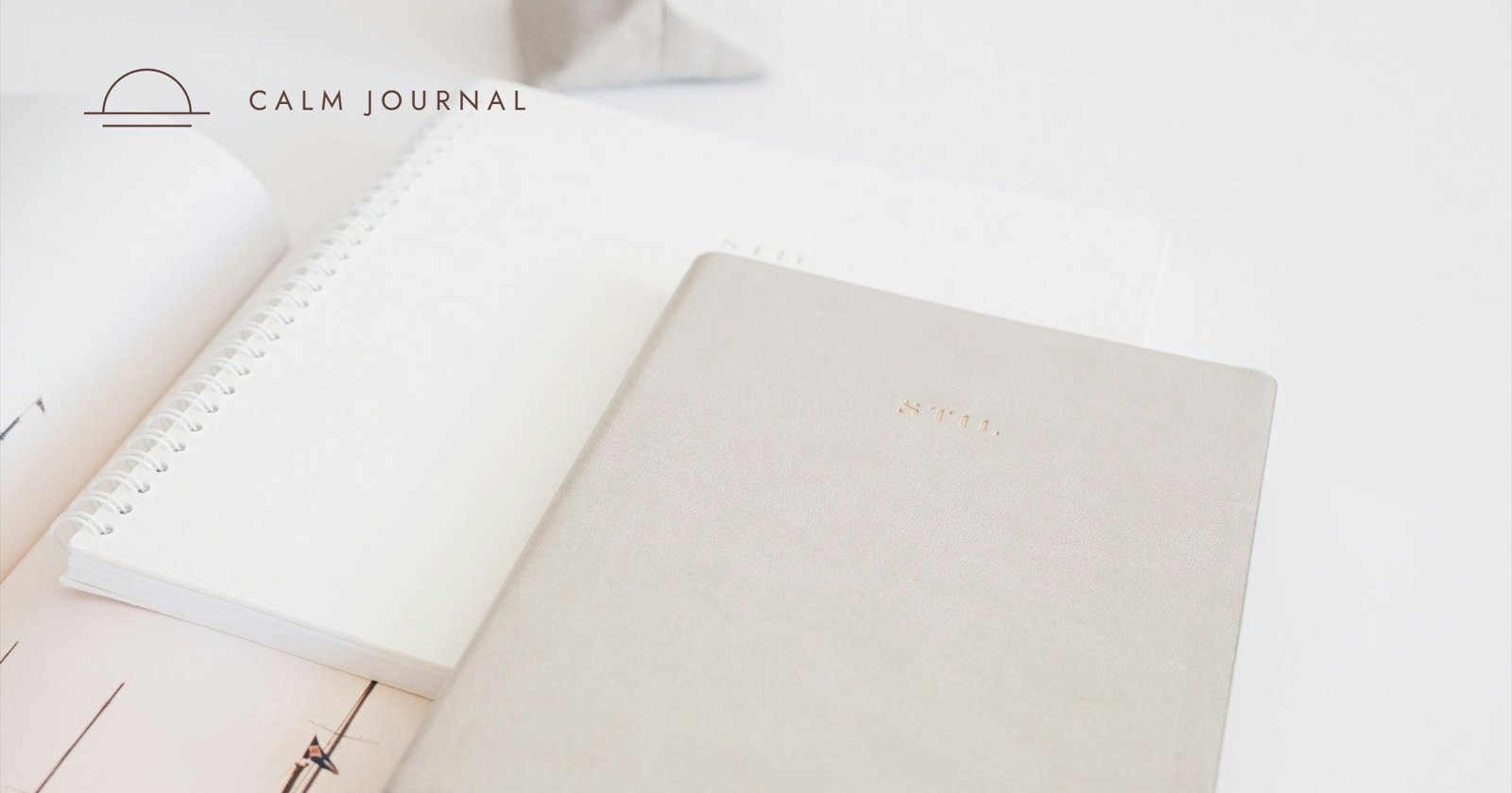 Beige planner on a white desk, Calm Journal cover for the post on Done List vs To-Do List
